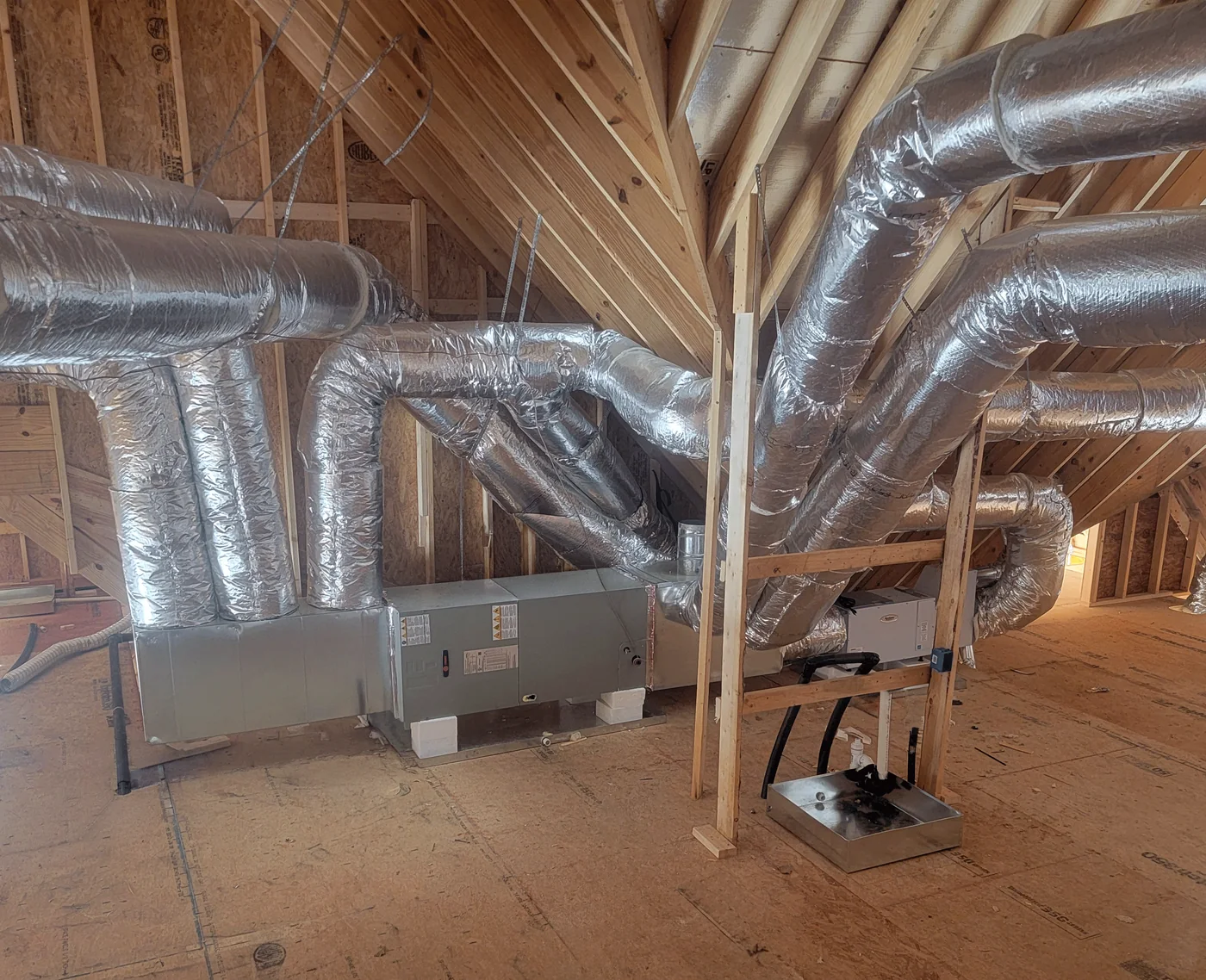 Installed HVAC system and ductwork in a residential new-construction attic space